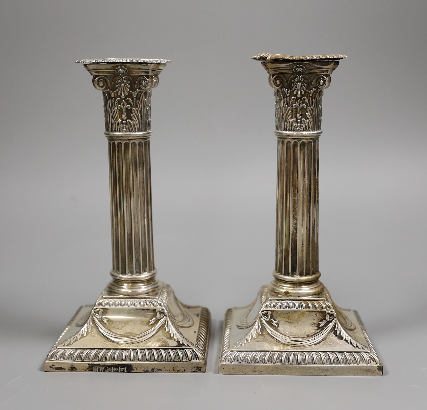 A pair of Edwardian silver Corinthian column candlesticks, Henry Wigful, Sheffield, 1904, height 19.7cm, weighted.
